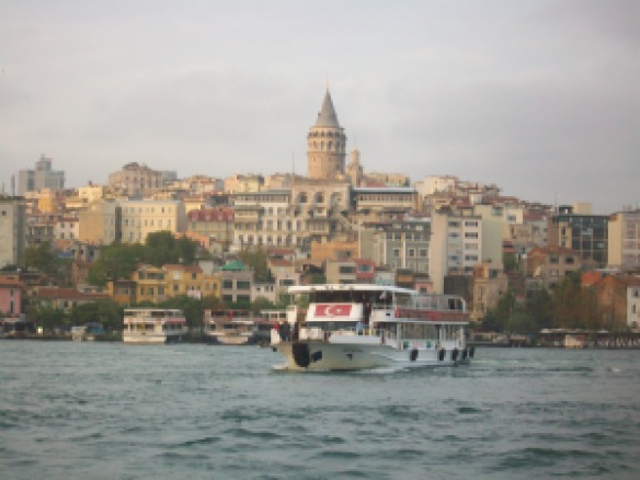 Galata Tower and ferryboat  with turkish flag